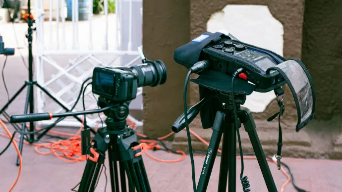 a camera and a tripod on a street